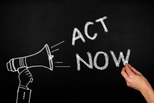act now with megaphone written on chalkboard